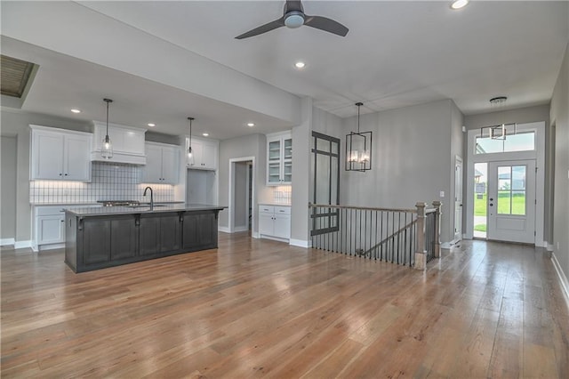 24105 W 58th Pl, Shawnee, KS 66226 - kitchen with white cabinets, light wood-style floors, decorative backsplash, recessed lighting, and a sink