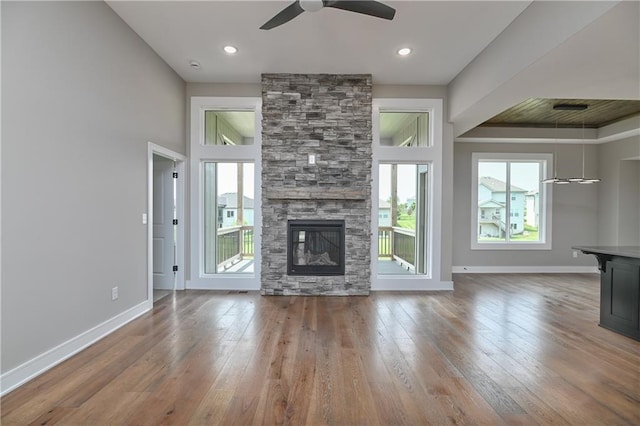 24105 W 58th Pl, Shawnee, KS 66226 - unfurnished living room featuring ceiling fan, plenty of natural light, hardwood / wood-style floors, and baseboards