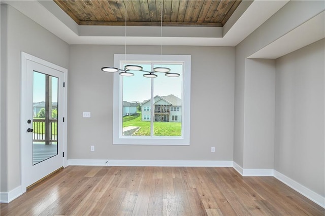 24105 W 58th Pl, Shawnee, KS 66226 - unfurnished dining area with wooden ceiling, a raised ceiling, light wood-style flooring, and baseboards