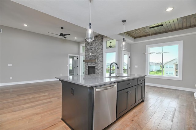 24105 W 58th Pl, Shawnee, KS 66226 - kitchen with stainless steel dishwasher, a sink, open floor plan, light wood finished floors, and baseboards