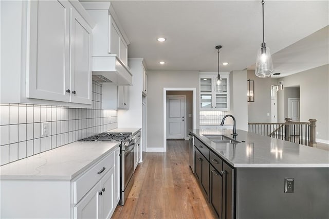 24105 W 58th Pl, Shawnee, KS 66226 - kitchen featuring stainless steel appliances, a sink, backsplash, an island with sink, and white cabinetry