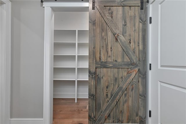 24105 W 58th Pl, Shawnee, KS 66226 - detailed view of a barn door and wood finished floors