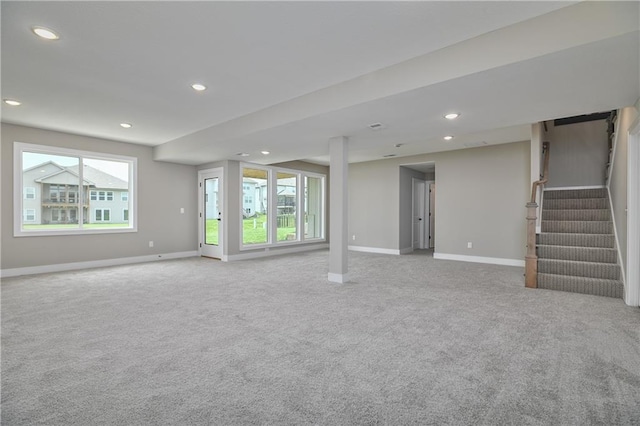 24105 W 58th Pl, Shawnee, KS 66226 - unfurnished living room featuring carpet, healthy amount of natural light, baseboards, recessed lighting, and stairway