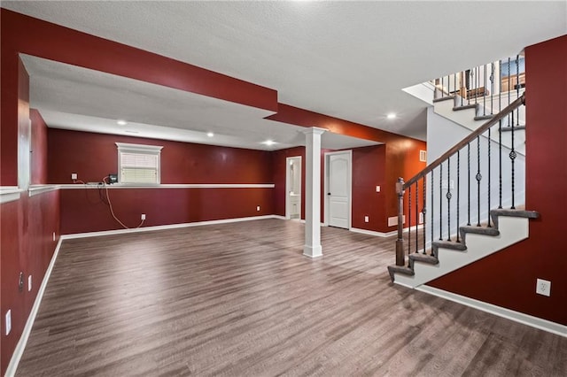 1523 Honeysuckle Dr, Liberty, MO 64068 - below grade area featuring wood finished floors, baseboards, stairway, and recessed lighting
