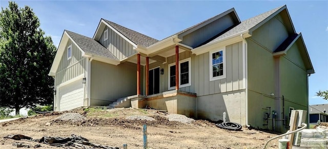 220 Rock Bridge Pkwy, Excelsior Springs, MO 64024 - view of front of home with roof with shingles, a garage, and board and batten siding