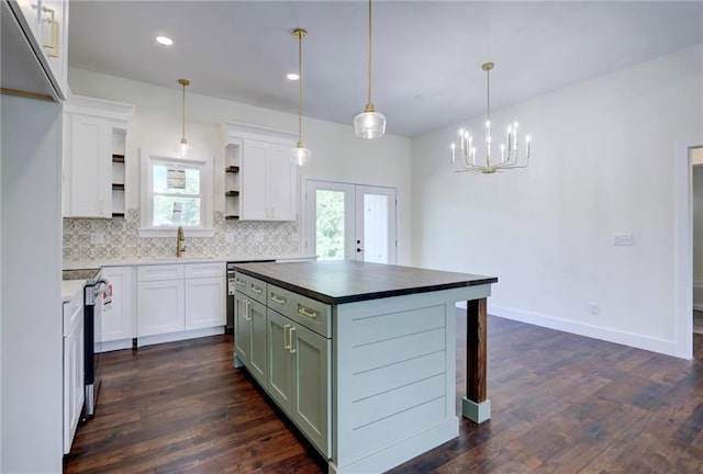 220 Rock Bridge Pkwy, Excelsior Springs, MO 64024 - kitchen with open shelves, tasteful backsplash, white cabinets, stove, and dark countertops