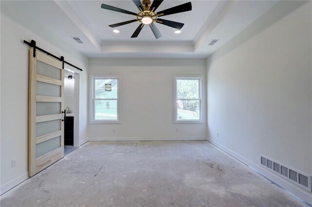 220 Rock Bridge Pkwy, Excelsior Springs, MO 64024 - unfurnished bedroom featuring a barn door, a tray ceiling, multiple windows, baseboards, and ornamental molding