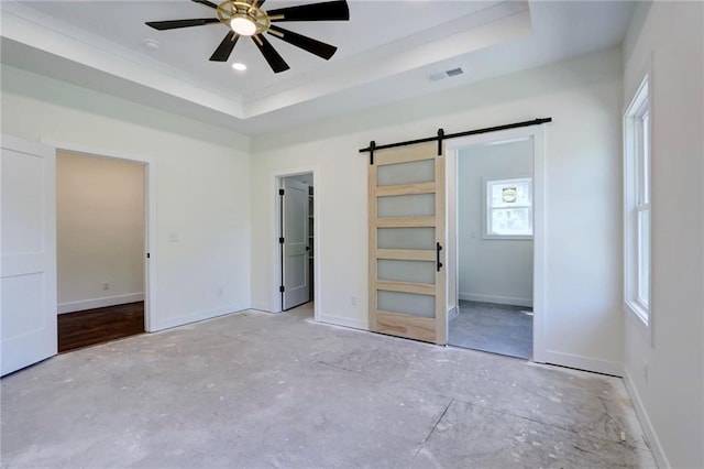 220 Rock Bridge Pkwy, Excelsior Springs, MO 64024 - unfurnished bedroom featuring a barn door, a raised ceiling, baseboards, and ceiling fan