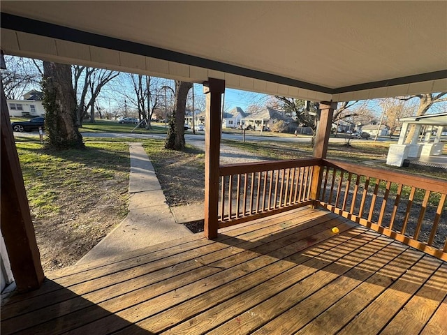 deck with covered porch and a residential view