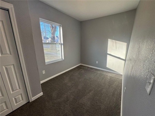unfurnished bedroom with carpet floors and baseboards