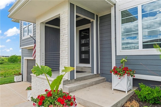 29702 W 195th St, Gardner, KS 66030 - property entrance featuring a garage, a porch, and concrete driveway
