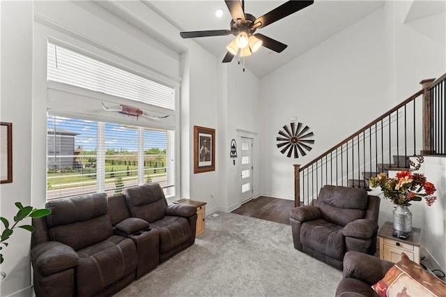 29702 W 195th St, Gardner, KS 66030 - living area featuring high vaulted ceiling, ceiling fan, stairs, carpet, and wood finished floors