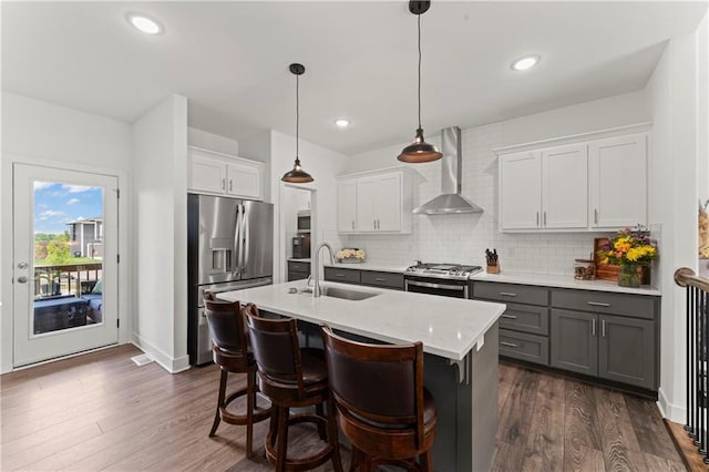 29702 W 195th St, Gardner, KS 66030 - kitchen with appliances with stainless steel finishes, wall chimney exhaust hood, a sink, gray cabinetry, and decorative backsplash