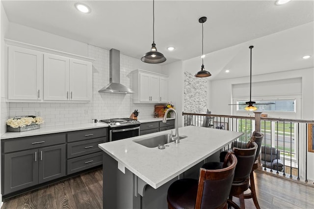 29702 W 195th St, Gardner, KS 66030 - kitchen with stainless steel range with gas stovetop, wall chimney exhaust hood, a sink, gray cabinets, and dark wood finished floors