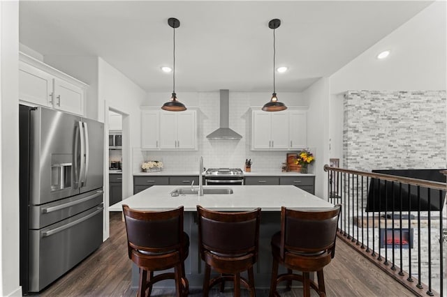 29702 W 195th St, Gardner, KS 66030 - kitchen featuring stainless steel appliances, wall chimney range hood, a sink, dark wood-style floors, and light countertops