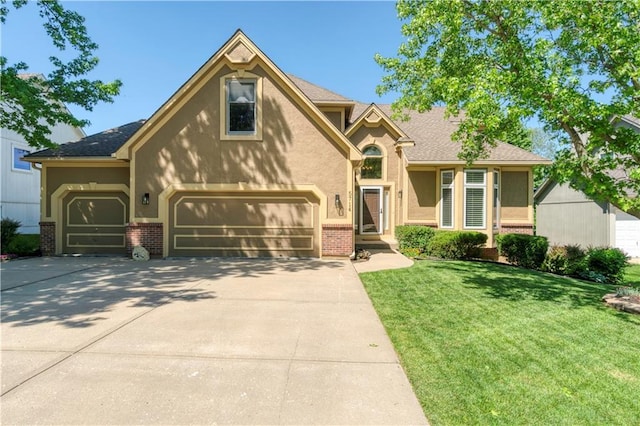 5714 Alden Ct, Shawnee, KS 66216 - view of front of property with brick siding, driveway, a front lawn, stucco siding, and a garage