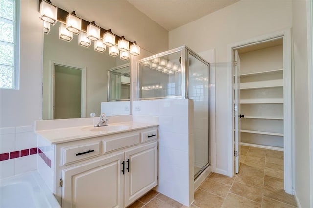 5714 Alden Ct, Shawnee, KS 66216 - full bath featuring a stall shower, vanity, a tub to relax in, a walk in closet, and tile patterned floors