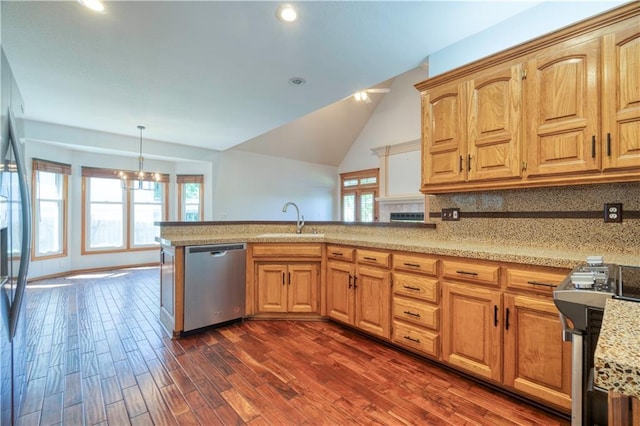 5714 Alden Ct, Shawnee, KS 66216 - kitchen featuring appliances with stainless steel finishes, a sink, dark wood-style flooring, tasteful backsplash, and a peninsula