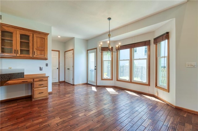 5714 Alden Ct, Shawnee, KS 66216 - kitchen with dark wood finished floors, a chandelier, brown cabinetry, baseboards, and pendant lighting