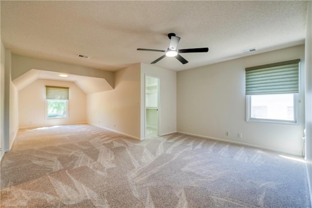 5714 Alden Ct, Shawnee, KS 66216 - additional living space with light colored carpet, a ceiling fan, baseboards, and a textured ceiling