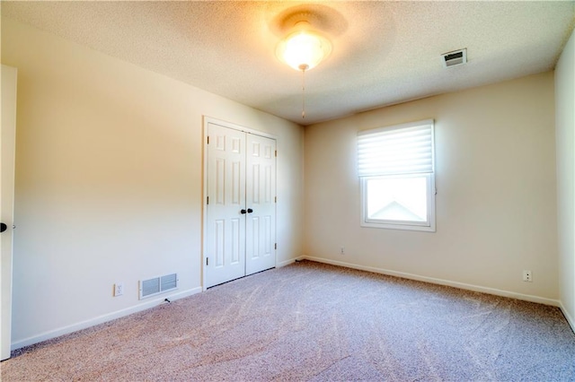5714 Alden Ct, Shawnee, KS 66216 - unfurnished bedroom featuring carpet, baseboards, a textured ceiling, and a closet
