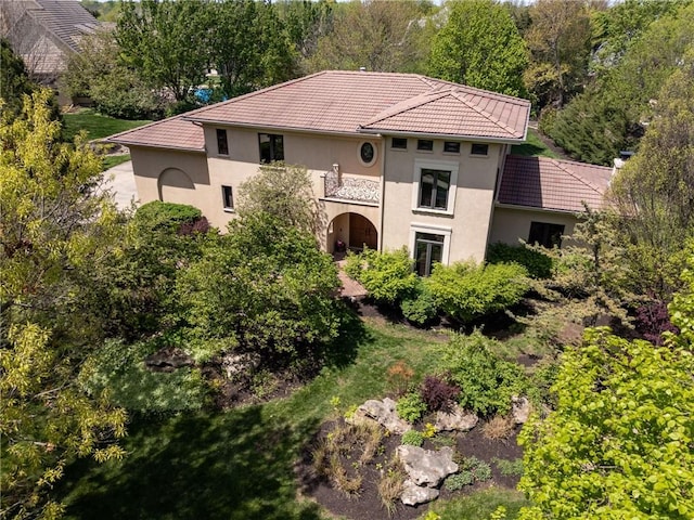 mediterranean / spanish-style home with stucco siding and a tiled roof