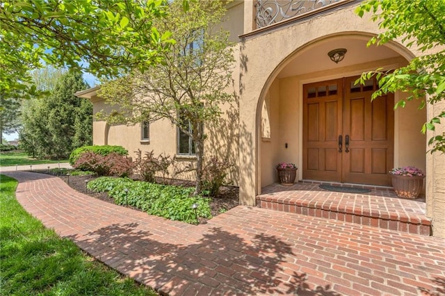 doorway to property featuring stucco siding