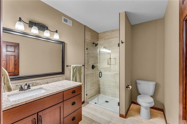full bath with a stall shower, toilet, vanity, baseboards, and tile patterned flooring