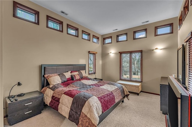 carpeted bedroom featuring a towering ceiling