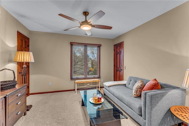 living area featuring a ceiling fan, light colored carpet, and baseboards