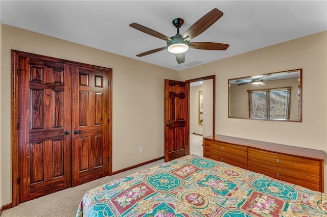 bedroom featuring light colored carpet, baseboards, and a ceiling fan