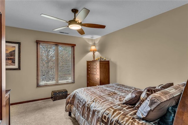 bedroom featuring light carpet, baseboards, and a ceiling fan