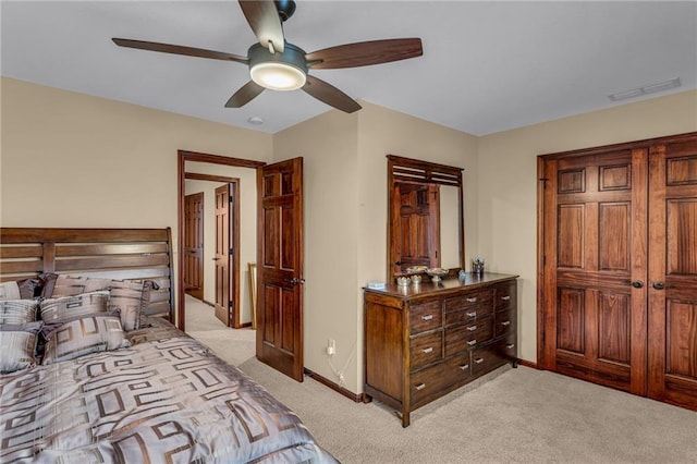 bedroom featuring light carpet, baseboards, and a ceiling fan