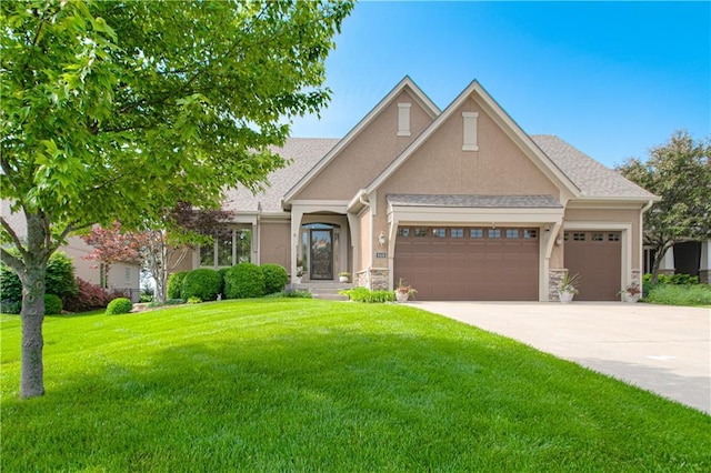 view of front facade with an attached garage, a front lawn, concrete driveway, stucco siding, and stone siding
