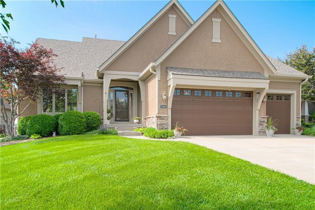 view of front of home featuring an attached garage, stone siding, a front lawn, driveway, and stucco siding