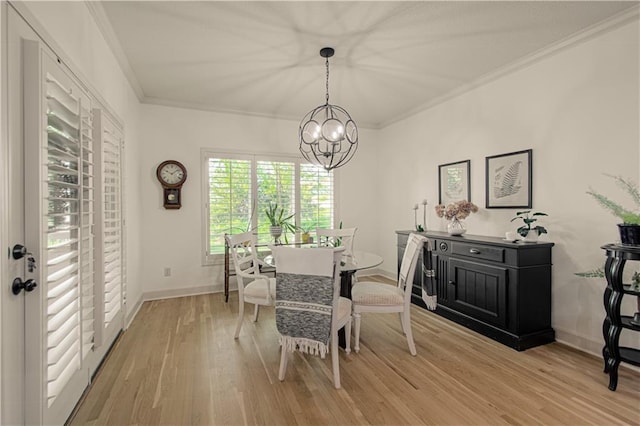 dining space with a chandelier, crown molding, light wood-style flooring, and baseboards