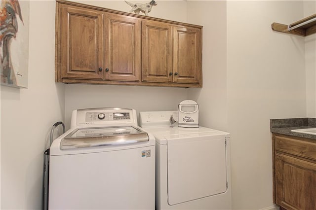 washroom with cabinet space and washing machine and clothes dryer