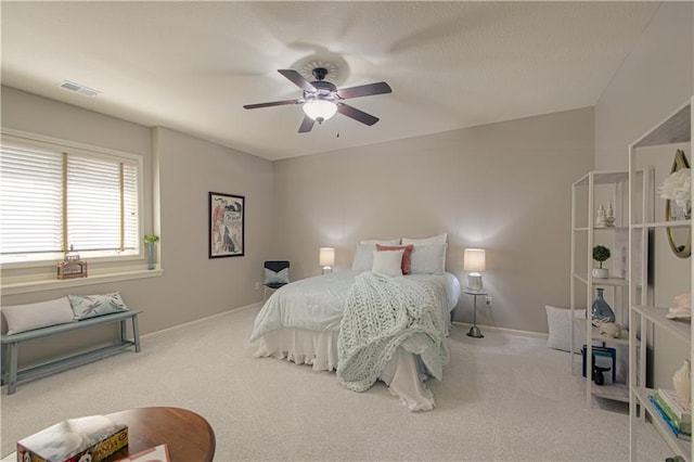 carpeted bedroom featuring baseboards and ceiling fan