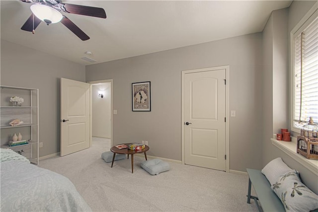 bedroom with light carpet, baseboards, multiple windows, and ceiling fan
