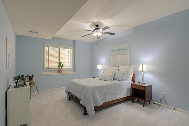 bedroom with light carpet, baseboards, and ceiling fan