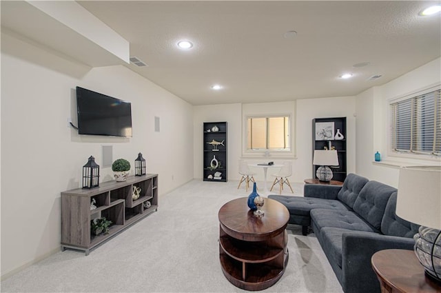 living area with light colored carpet and recessed lighting