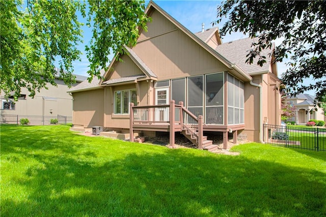 back of property featuring a sunroom, a shingled roof, and a wooden deck