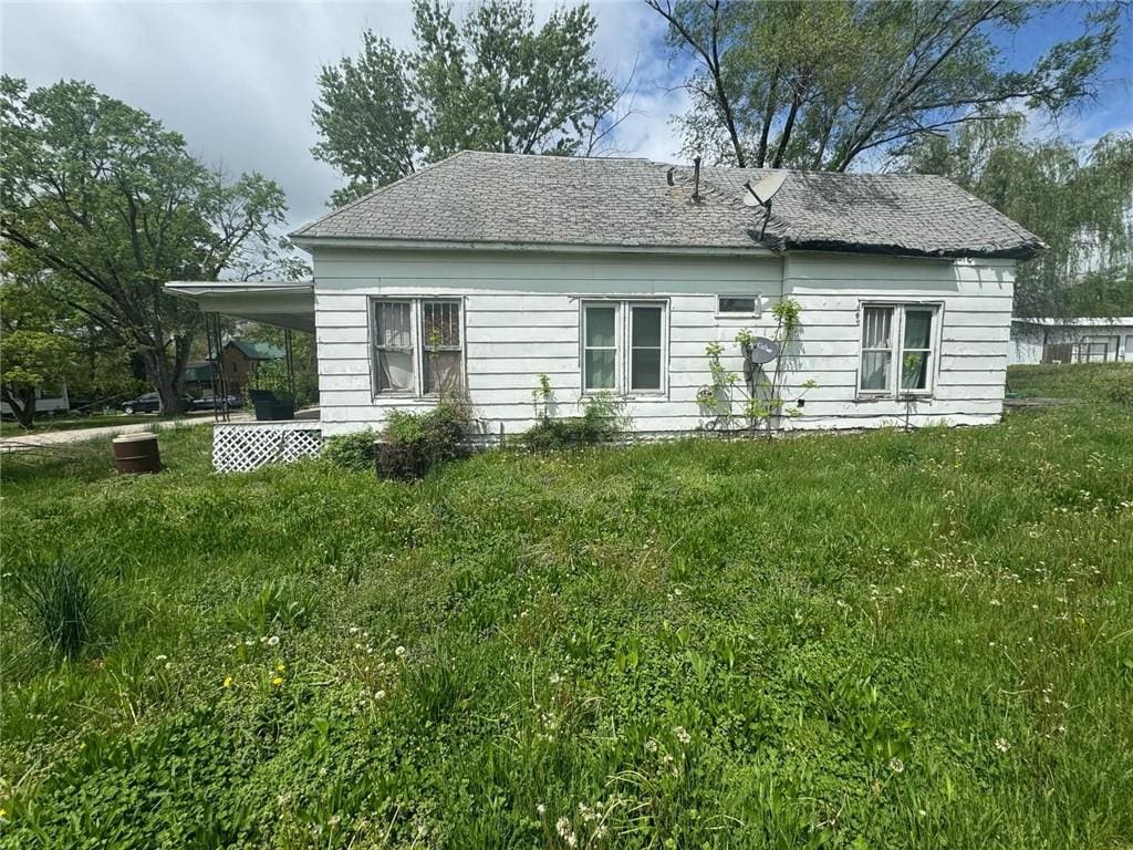 121 E Truman St, Marceline, MO 64658 - view of home's exterior featuring a carport