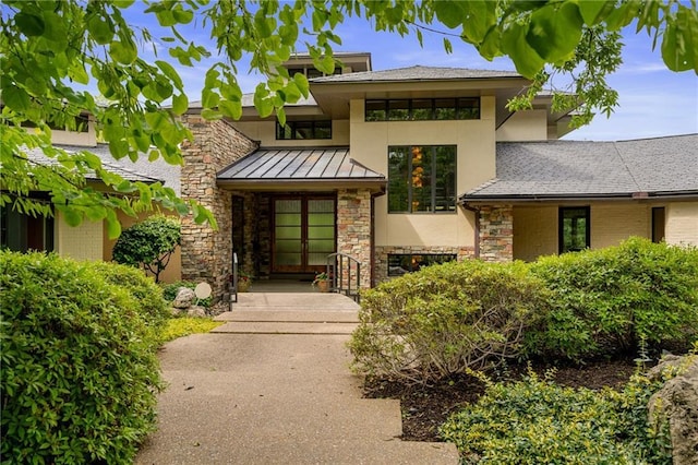 8700 Lee Blvd, Leawood, KS 66206 - view of front facade with stone siding, a standing seam roof, stucco siding, and metal roof