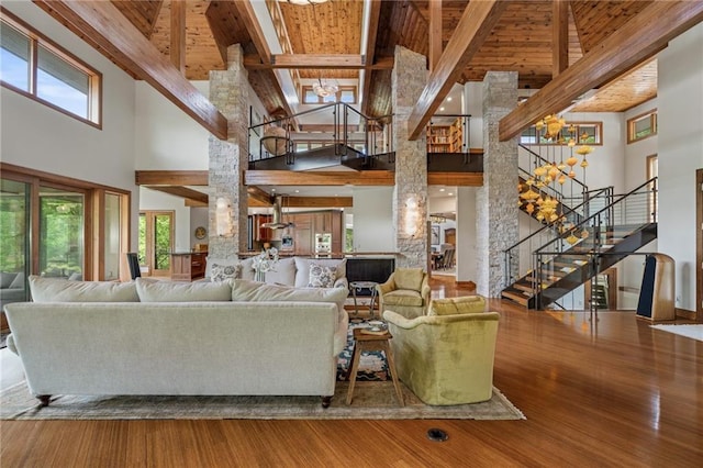 8700 Lee Blvd, Leawood, KS 66206 - living room featuring a towering ceiling, stairs, plenty of natural light, wood finished floors, and wood ceiling with exposed beams