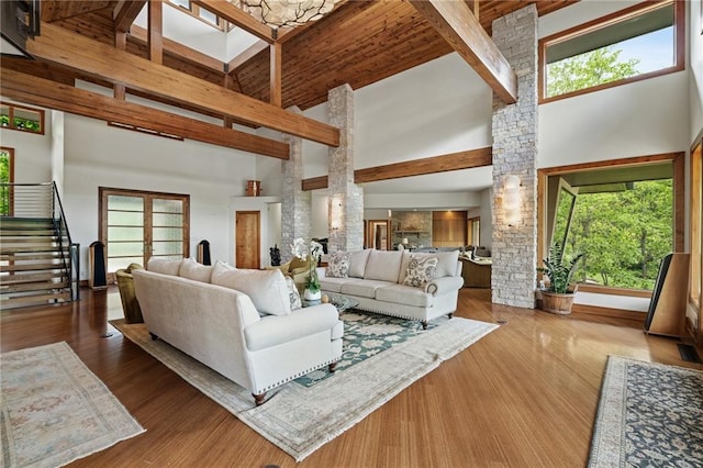 8700 Lee Blvd, Leawood, KS 66206 - living room featuring high vaulted ceiling, stairway, beam ceiling, healthy amount of natural light, and decorative columns