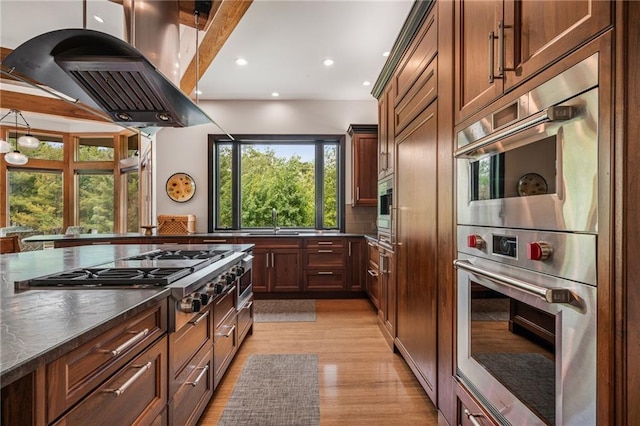 8700 Lee Blvd, Leawood, KS 66206 - kitchen featuring appliances with stainless steel finishes, island range hood, dark countertops, recessed lighting, and light wood finished floors