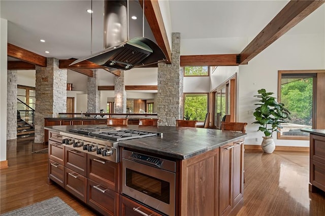 8700 Lee Blvd, Leawood, KS 66206 - kitchen with stainless steel appliances, decorative columns, beam ceiling, dark wood-style flooring, and dark countertops