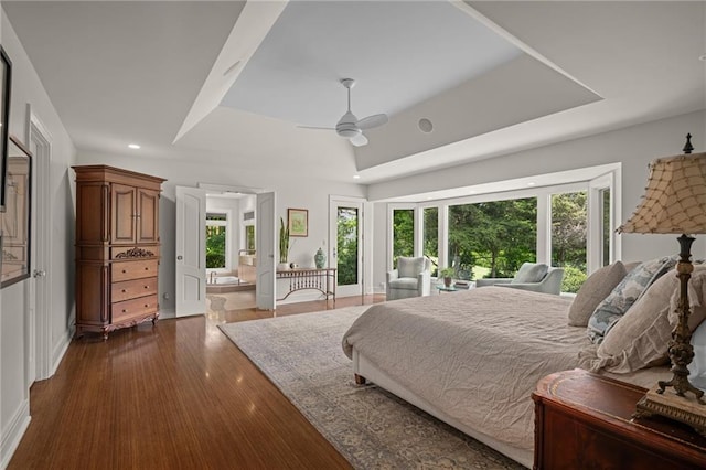 8700 Lee Blvd, Leawood, KS 66206 - bedroom with a tray ceiling, multiple windows, dark wood-style floors, recessed lighting, and baseboards