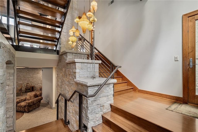 8700 Lee Blvd, Leawood, KS 66206 - stairway featuring baseboards, a chandelier, and a high ceiling